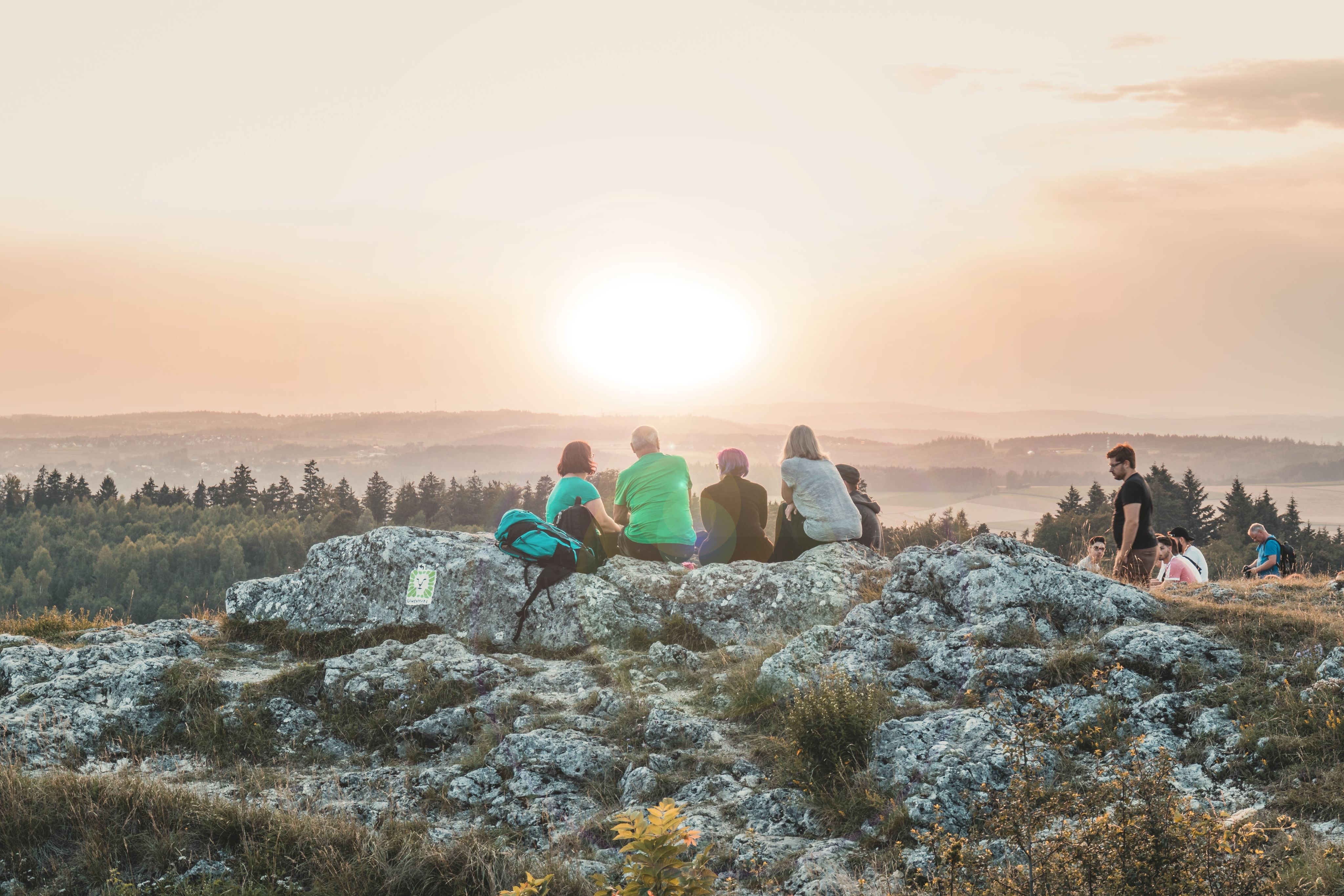 people sitting watching sun rise