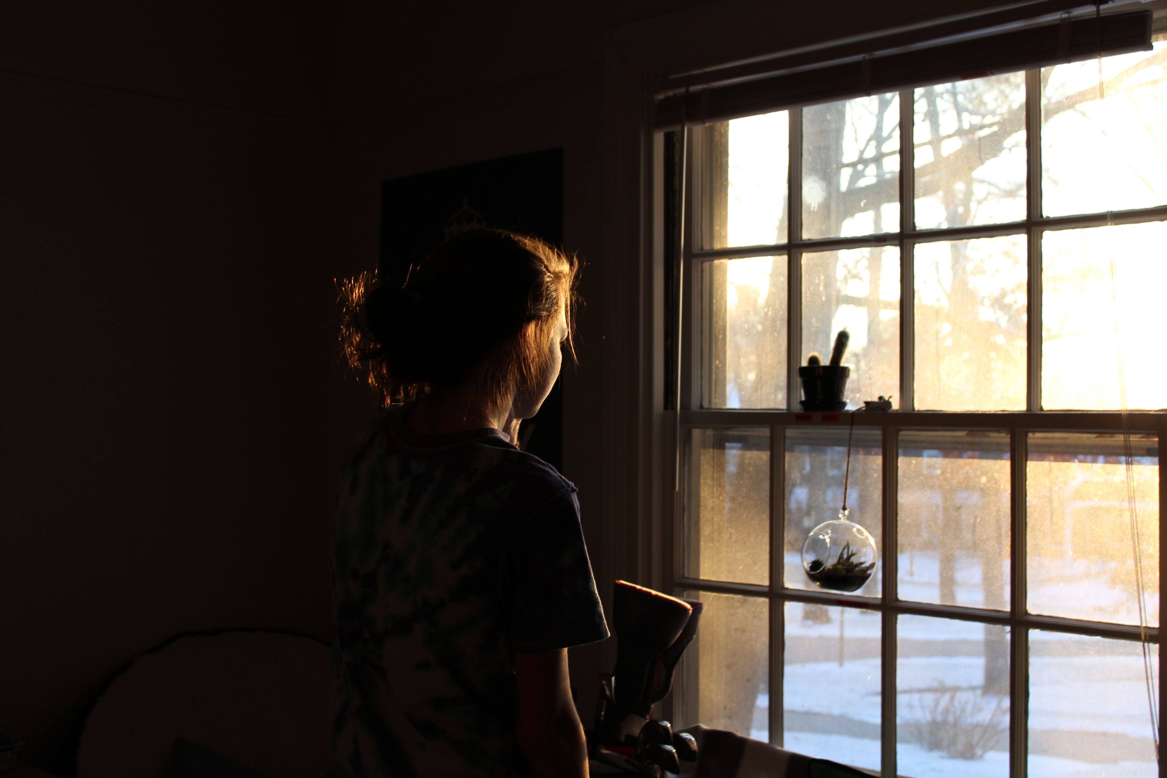 woman in room facing window